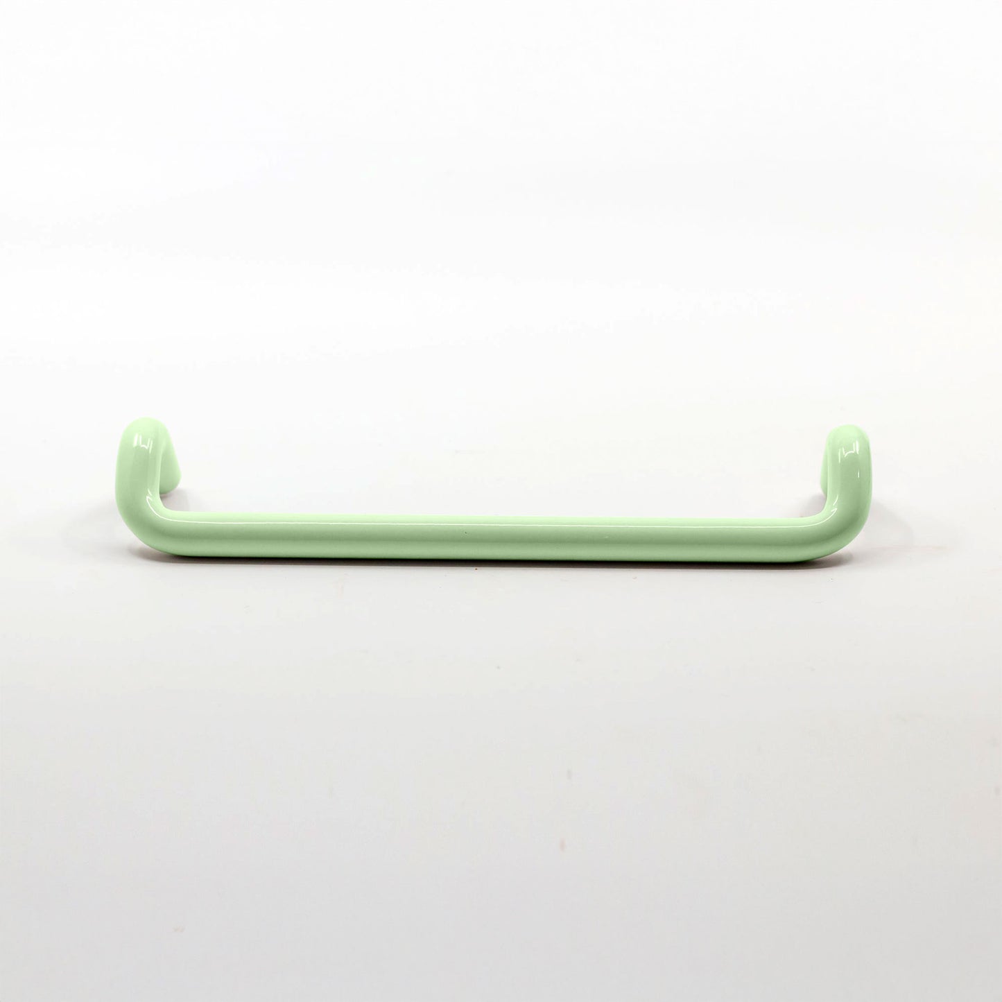 A single pale mint green metal cabinet pull  with a glossy finish, shown horizontally against a plain white background.