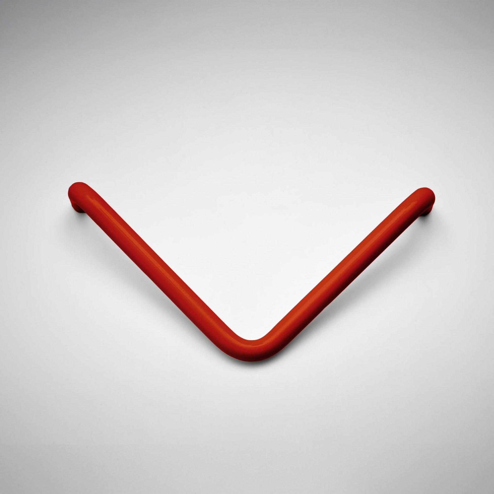 A curved, V-shaped metal cabinet pull in a matte red finish, displayed on a clean light gray background.