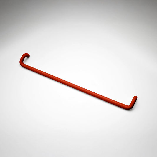 A minimalist red metal cabinet pull with a curved, modern design, shown on a clean light gray background.