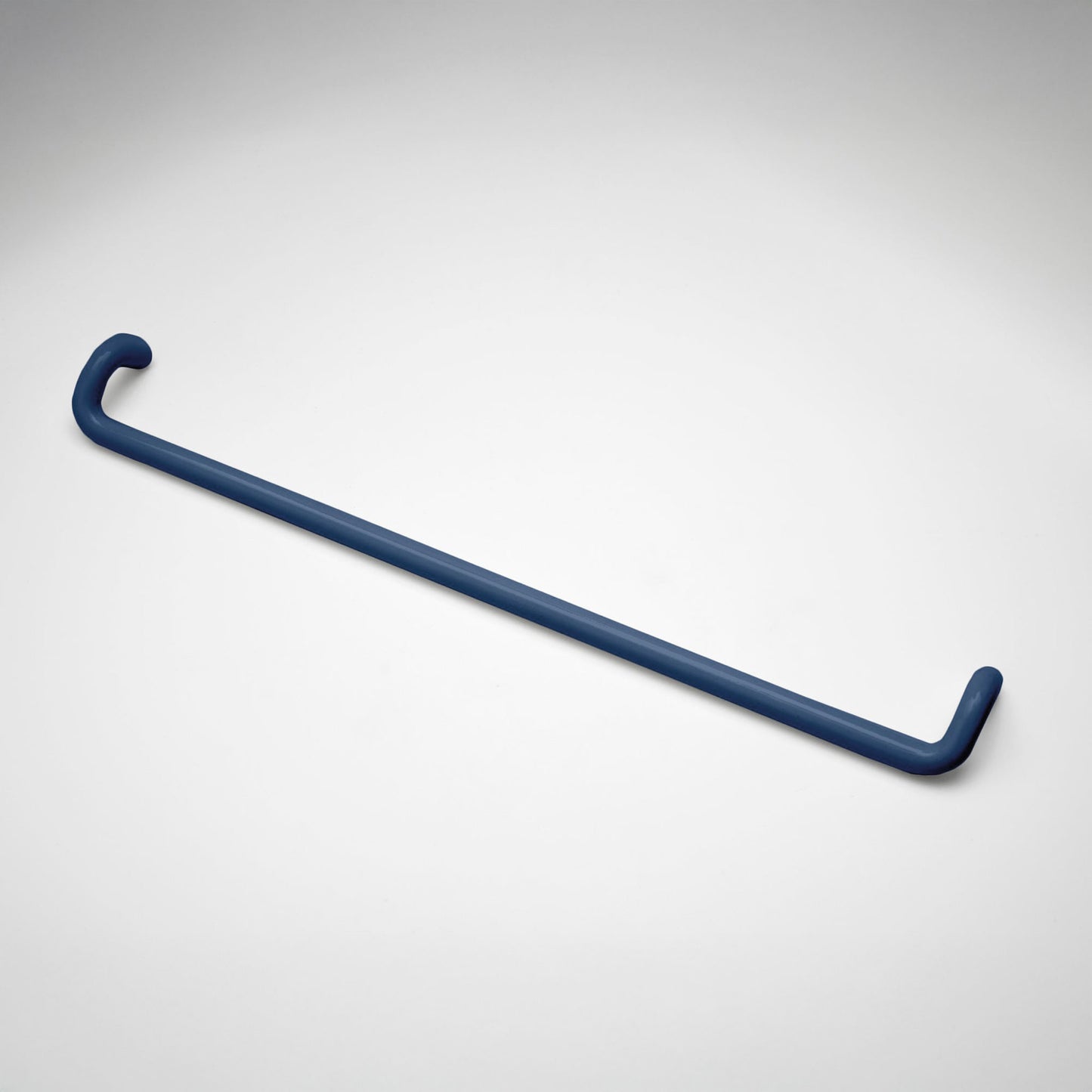 A minimalist navy metal cabinet pull with a curved, modern design, shown on a clean light gray background.