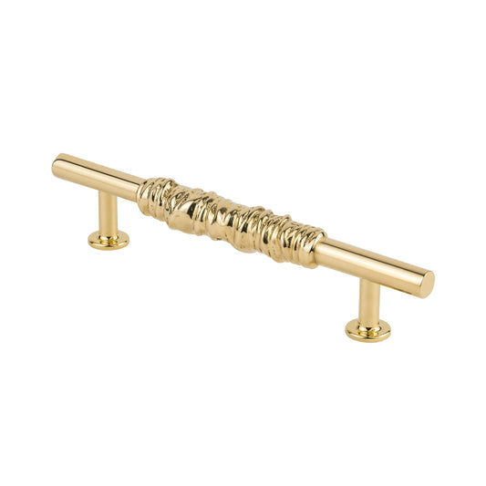 Side view of a brass textured cabinet pull handle on a white background